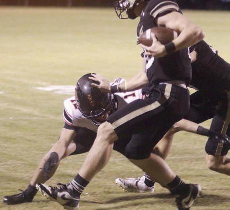 Eli Blansitt fights through a block to cut down quarterback Cash Lamb on a fourth-quarter scramble. Sticker Photo By Darrell Vyvjala