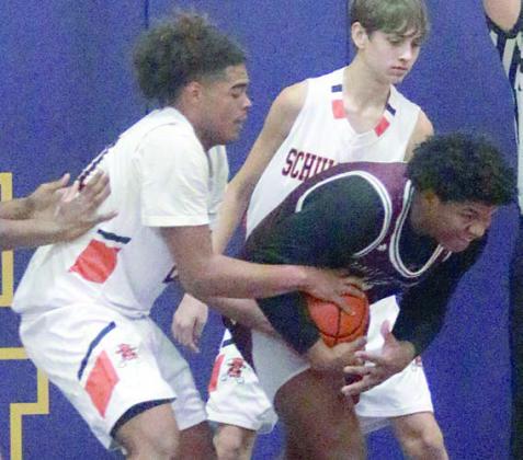 Jayvan Luhrs ties up a Brahma on the defensive end of the court Thursday morning. Sticker Photo By Darrell Vyvjala