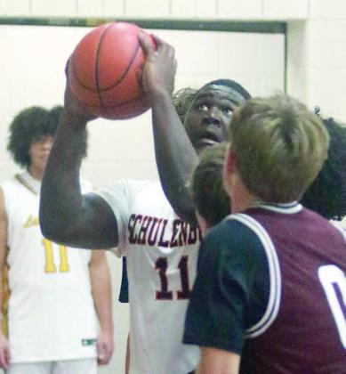 Tavondrick Ellison goes up to score under the basket in the second half of the Horns’ win to start the tournament in La Grange. Sticker Photo By Darrell Vyvjala