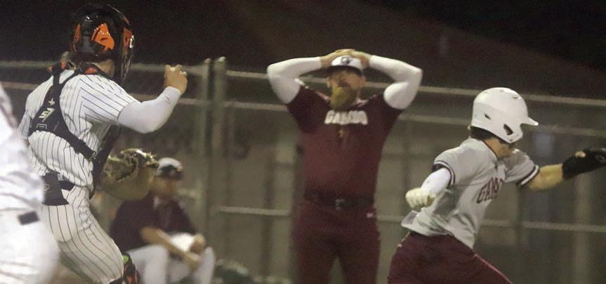 Catcher Jayse Janda runs an Indian toward third base for an out after a failed suicide squeeze bunt, to the dismay of a Ganado coach. Sticker Photo By Darrell Vyvjala