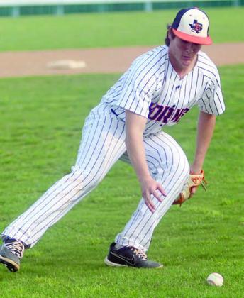 Pitcher Owen Brenek goes to get a dribbler for an out versus Sacred Heart. Sticker Photo By Darrell Vyvjala