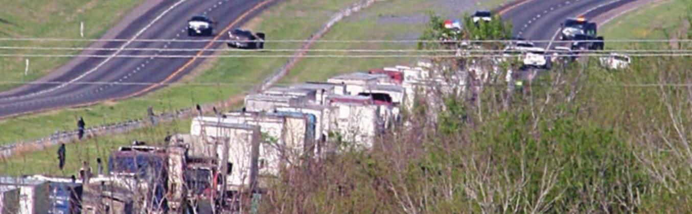 I-10 westbound traffic backs up during the standoff west of Schulenburg Thursday morning. Sticker Photo By Darrell Vyvjala