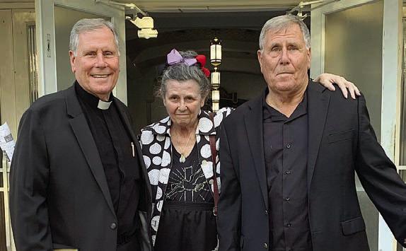 After his installation, Fr. Jasper Liggio (left) is shown with his sister Pamela Liggio (center) and identical twin brother Vincent Liggio (right). Sticker Photo By Bernadette Gillings