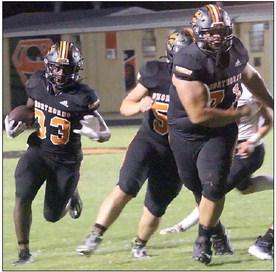 Calvin Thompson (right) and Tyson Wagner lead the way for a 13-yard gain in the third quarter by Rodney H Walton (No. 33).