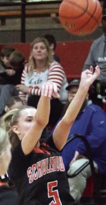 Jenna Guentert releases one of her three first-half treys. Sticker Photo By Darrell Vyvjala
