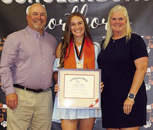 Tamara Otto (center) accepts the valedictorian plaque at the Senior Scholarship Banquet earlier this month with her parents, Keith and Stacy Otto. Photo By Audrey Kristynik