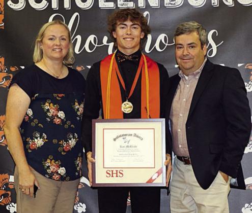 Kaz McBride (center), with his parents Kristi and Shannon McBride at his side, receives the salutatorian award at the Senior Scholarship Banquet. Photo By Audrey Kristynik