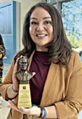 Nicole Gabler shows off the A&amp;M Outstanding Alumni/Former Student of the Year Award she received.