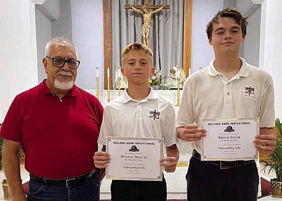 Outstanding SoloISTs – Weston Hollas (center) and Brock Seger (right), with band director Julius Castillo (left).