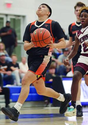Victor Mandujano stays ahead of a Hearne defender to go up for a fast-break basket in the final period. Photo By Ricky Toro