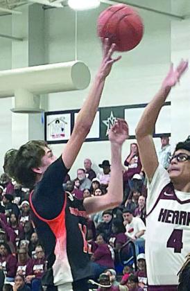 Adam Schramek scores in the lane over an Eagle in the fourth quarter. Sticker Photo By Darrell Vyvjala