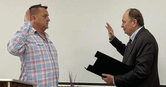 Chairman sworn in – Michael P. Schlabach (left) was sworn in as chairman of the Fayette County Republican Party by County Judge Dan Mueller (right).
