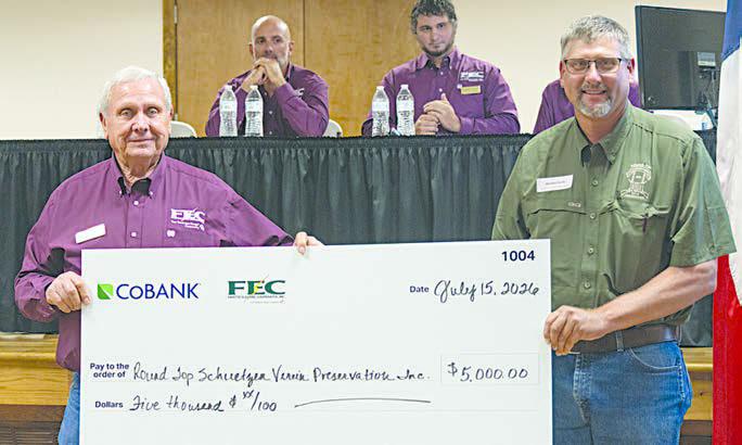 Round Top Schuetzen Verein Preservatio n Inc. received $5,000 for renovation projects at its historic hall. Shown are (foreground, from left) FEC board president Joseph Kruppa; and Michael Sacks, vice president of community affairs for Round Top Schuetzen Verein Preservation Inc.