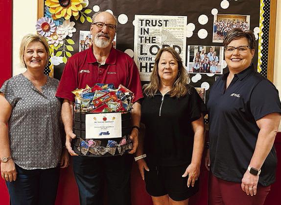 Presentation at St. Rose of Lima Catholic School – (from left) Jeannie Mican, administrative assistant; Mike Olle, FSB; Sandy Zaruba, athletic director; and Cheryl Brossmann, FSB.