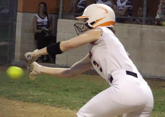 Fay Kutac puts down a sacrifice bunt as part of the Lady Horns’ six-run third inning Friday. Sticker Photo By Darrell Vyvjala