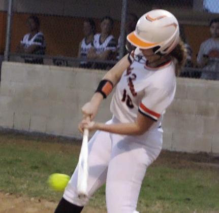 Grace Schramek sends an RBI-single up the middle against Moulton. Sticker Photo By Darrell Vyvjala