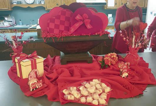 Both the centerpiece (left photo)) and the table centerpieces (right photo) reflected a Valentine’s theme.
