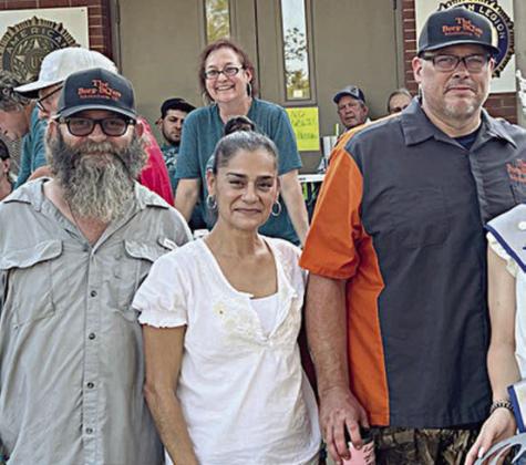 78956 (LOCAL) CHAMPION – “The Burg-BQ’ers,” represented by (from left) Chris Mache, Serena Bradley, and David Bradley. Sticker Photo By Kade Vyvjala