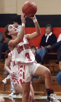 Kendra Salmon drives to the basket for a layup in the Lady Horns’ season opener. Sticker Photo By Darrell Vyvjala