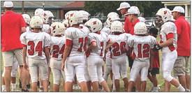 St. Rose coaches talk to the Cardinal players during their first game in El Campo last week.