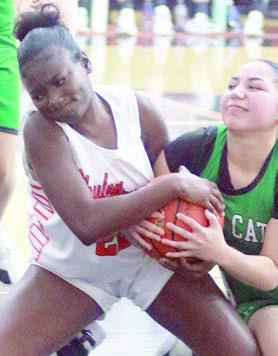 Madison Harris battles a Lady Bobcat for a loose ball in the fourth quarter. Sticker Photo By Darrell Vyvjala