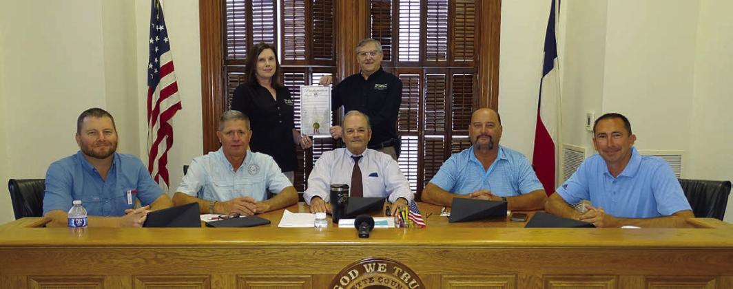 On hand for the proclamation commemorating FEC’s 85th anniversary were: (front, from left) Precinct 4 Commissioner Drew Brossmann, Precinct 3 Commissioner Harvey Berckenhoff, County Judge Joe Weber, Precinct 2 Commissioner Luke Sternadel, Precinct 1 Commissioner Jason McBroom; (back, from left) FEC Marketing and Training Coordinator Tracy Denton, and FEC General Manager Gary Don Nietsche. Photo By Melanie Berger / Courtesy of Flatonia Argus