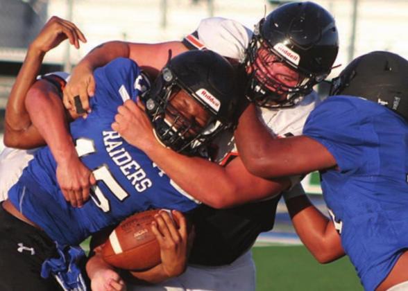 Nathan Ricicar wraps up a Raider in the backfield. Sticker Photo By Darrell Vyvjala