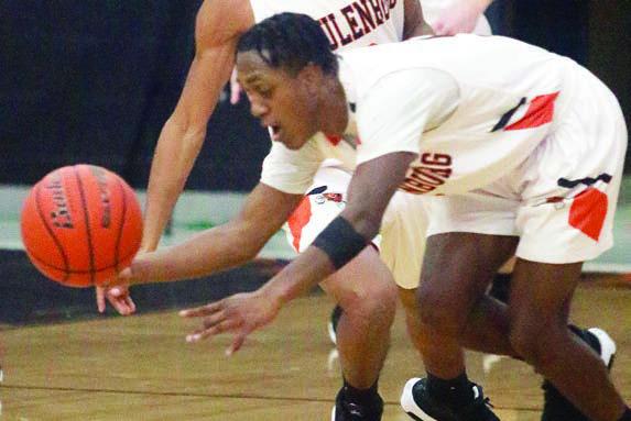 Demarrion Glass gets a steal near midcourt in the first half against Bloomington. Sticker Photo By Darrell Vyvjala
