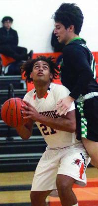 Jayvan Luhrs draws a foul on a first-quarter shot under the basket last Tuesday. Sticker Photo By Darrell Vyvjala