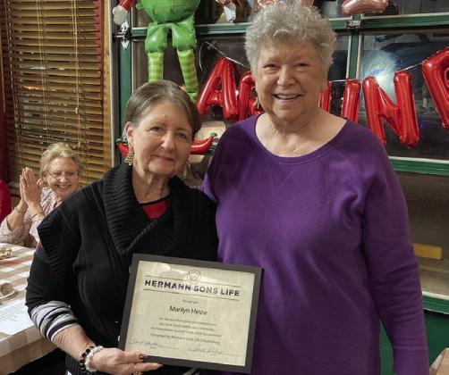 Marilyn Hinze (left) accepts the Humanitarian of the Year Award from Junette Rodecap, who serves as chair of the award committee for Hermann Sons Life.