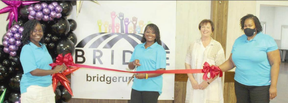 On hand for a ribbon cutting at Saturday’s meet-and-greet community social were: (from left) BRIDGE executive directors Rebecca Powe and LaKeisha Brown-Moore, Schulenburg Chamber of Commerce Executive Director Terri Wagner, and BRIDGE Executive Director LaToya Kindred-Ray.