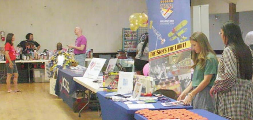 The three photos above show some of the vendors and visitors at Saturday’s community social sponsored by BRIDGE. Sticker Photos By Darrell Vyvjala