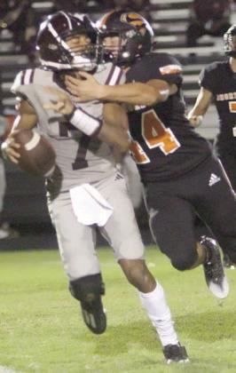 Aiden Mendez forces an intentional grounding with his quarterback pressure in the second quarter. Sticker Photo By Layne Vyvjala