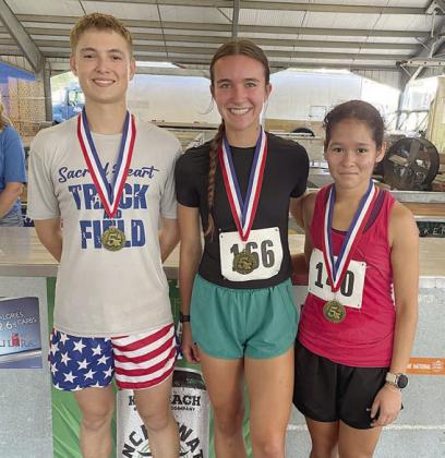 Cross country winners – (from left) Ryan Janak, top high school make (20:58.326); Lily Alexander, top high school female (22:38.965); and Alexa Moreno, top junior high female (23:04.511). Not shown: Peyton Brown, top junior high male (22:20.642). Sticker Photo By Darrell Vyvjala