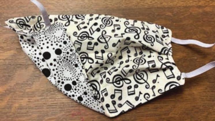 Another example of a specialty mask that is reversible is the music-themed mask at left, being worn by Carrie Castleman in the photo at right.