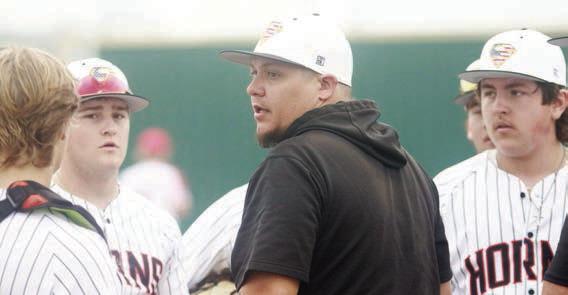 Head coach Marty Bigham (center) chats with his players between innings during a tournament game last week. Sticker Photo By Darrell Vyvjala