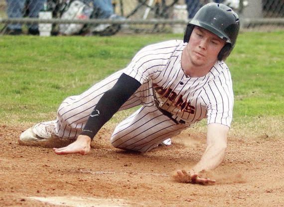 Nick Goode slides into home plate after avoiding Burton’s catcher in the second inning.