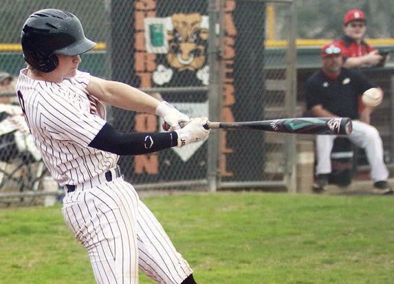 Emerson Harvey connects for an RBI-single against Burton. Sticker Photo By Darrell Vyvjala