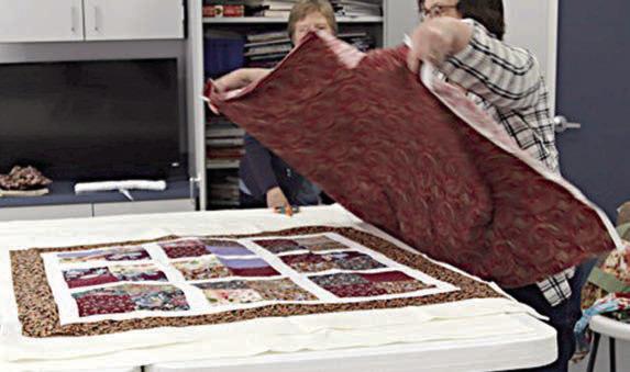 At the charity quilt workshop, stations were set up at which members performed various tasks (top photo), including (bottom left photo) “sandwiching” the quilt and (bottom right photo) cutting the fabric, with Sandy Courrier shown at the cutting table.