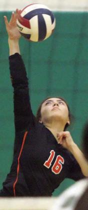 Kelly Netro serves an ace in the third set. Sticker Photo By Darrell Vyvjala