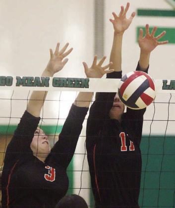 Meredith Magliolo (right), with Reagan Dusek alongside, gets a block in game one.
