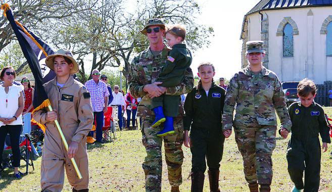 The Prisoners of War /Missing in Action flag was brought forward by the Kopecky family – (from left) Marshall, Michael holding Miles, Madison, Theresa and Maxwell.