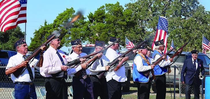 Veterans performing the triple volley salute included (from left) Commander Joe Gajdos, Luciano Martinez, Joe Cockrell, Dennis Geesaman, David Fike, Mike Whitten, Dennis Muhlstein and Henry Miksch. At far right is Dennis Olsovsky, who is about to play “Taps.”