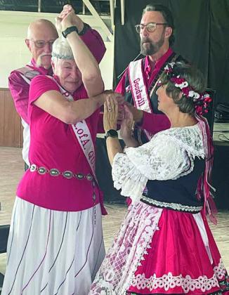 PHOTO ABOVE – King and queen of the Polka Lovers Klub of America are C.W. “Chris” and Doris Benson. PHOTO AT RI GHT – Giving instructions on some dance moves to C.W. “Chris” and Doris Benson (left) are Louis and Deb Stewart (right).