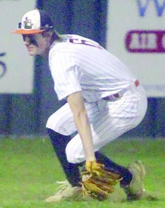 Zane Brenek reaches down to get to a Bulldog fly ball in shallow left field. Sticker Photo By Darrell Vyvjala