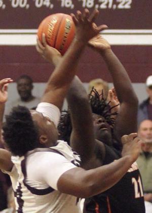 Tavondrick Ellison goes up after an offensive rebound and draws a foul in the second quarter last Tuesday. Sticker Photo By Darrell Vyvjala