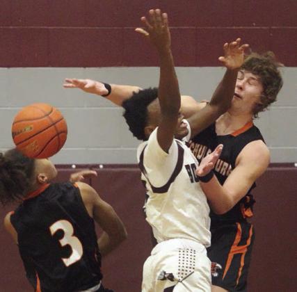 Aaron Janecek rejects a Bulldog shot in the first half. Sticker Photo By Darrell Vyvjala