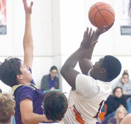 Tavondrick Ellison scores in the lane after an offensive rebound in the second quarter against Shiner. Sticker Photo By Darrell Vyvjala