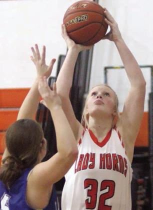 Ava Bubela scored under the basket in the fourth quarter on Dec. 19. Sticker Photo By Darrell Vyvjala