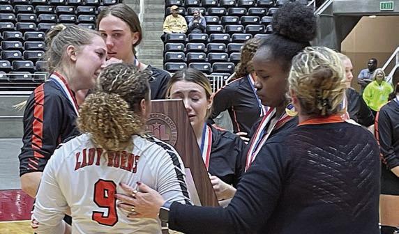 Kieryn Adams (No. 9) with fellow seniors (from left) Brooke Redding, Meredith Magliolo, Keaton Walker, and Jessalyn Gipson accept the state semifinal trophy from High School Principal Callene Zapalac. Sticker Photo By Darrell Vyvjala